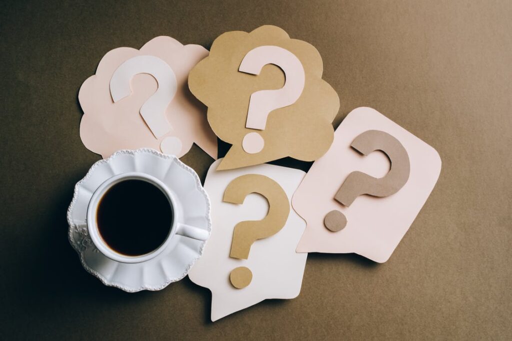question marks on paper crafts and a cup of coffee