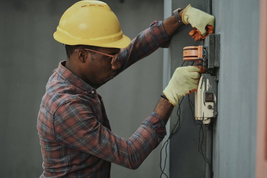 Electrician repairing a fuse box