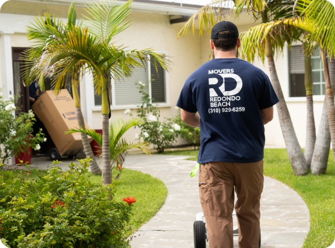 Movers posing in front of a truck
