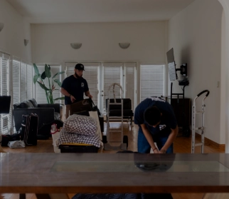 Movers holding a packed household item